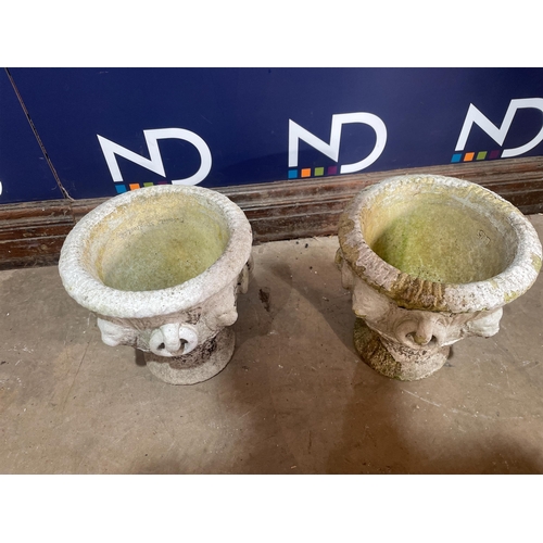 69 - A PAIR OF COMPOSITE STONE URNS