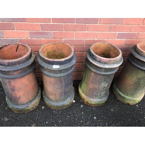 19 - FOUR TERRACOTTA CHIMNEY POTS