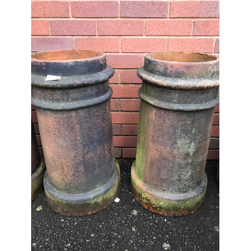 19 - FOUR TERRACOTTA CHIMNEY POTS