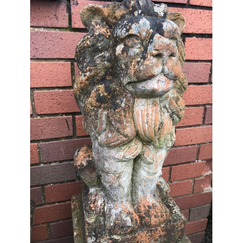 21 - PAIR OF TERRACOTTA STONE LIONS ON PLINTHS