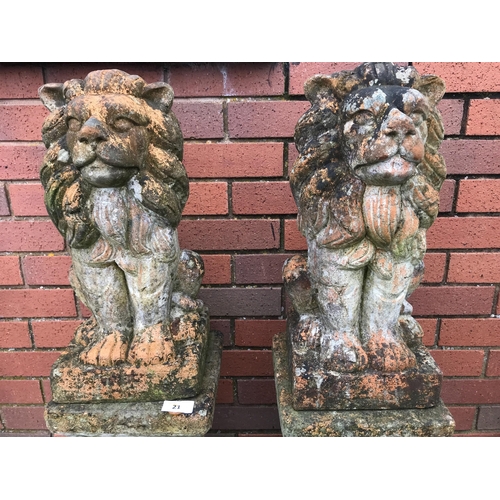 21 - PAIR OF TERRACOTTA STONE LIONS ON PLINTHS