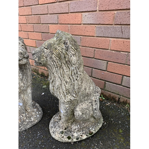 76 - PAIR OF COMPOSITE STONE LIONS
