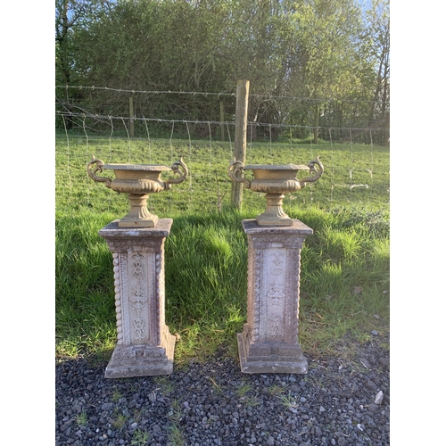 37 - PAIR OF CAST URNS ON PEDESTALS