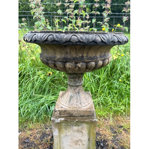 41 - COMPOSITE STONE URN ON PLINTH