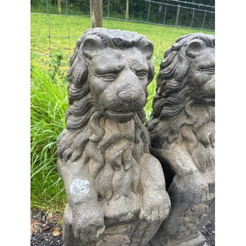 46 - PAIR OF COMPOSITE STONE LIONS