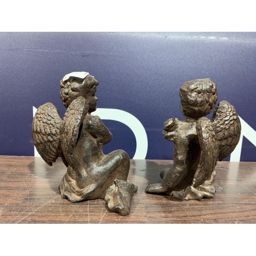 521 - TWO CAST IRON CHERUBS