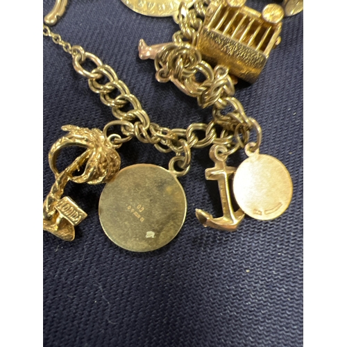 143 - 9CT GOLD CHARM BRACELET CTW 29GM