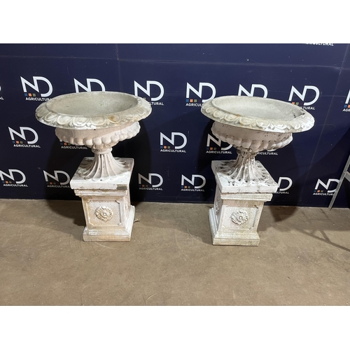 64 - PAIR OF COMPOSITE STONE URNS