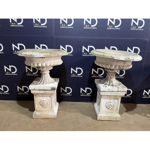 64 - PAIR OF COMPOSITE STONE URNS