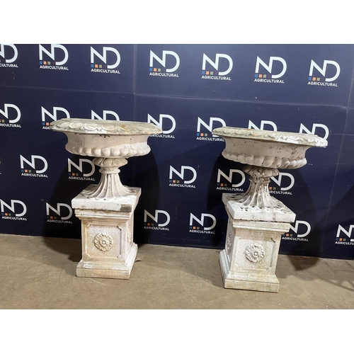 64 - PAIR OF COMPOSITE STONE URNS