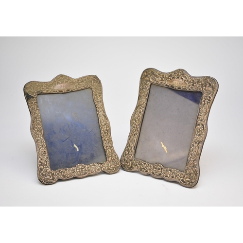 28 - A pair of Edwardian silver photograph frames, makers mark indistinct, Chester 1904, each of shaped r... 