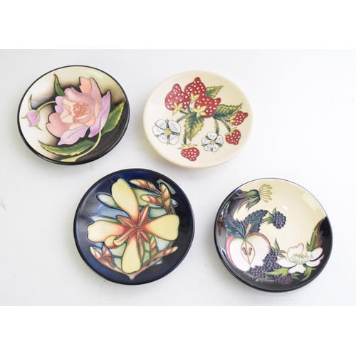 359 - A group of four Moorcroft pin dishes, comprising an example with Apples designed by Nicola Slaney, d... 