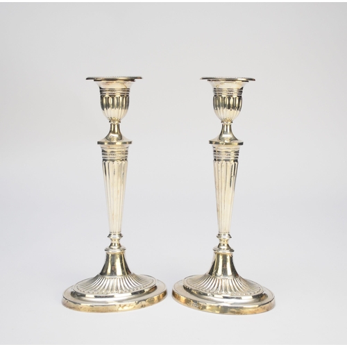 4 - A pair of early 20th century silver mounted candlesticks, Fordham & Faulkner, Sheffield 1907, each o... 