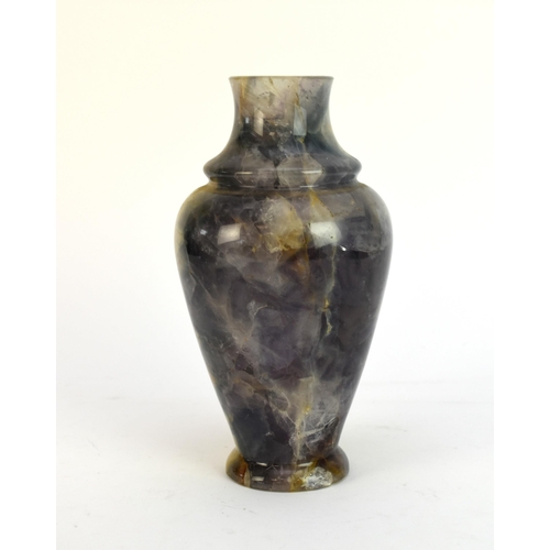 516 - A polished quartz vase, probably 19th century, of ovoid form with blue, purple and yellow inclusions... 