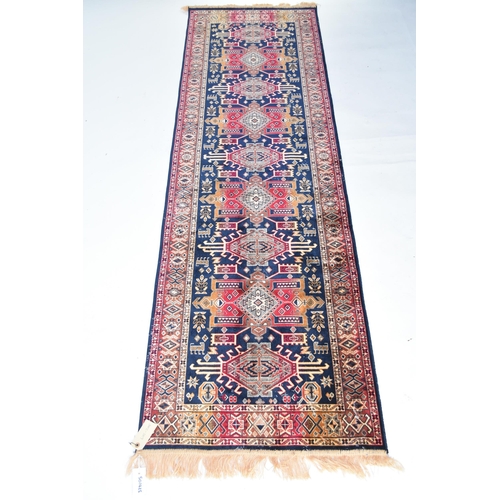 585 - A Heriz runner, 70cm x 228cm