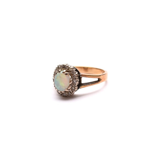 62 - An oval opal and diamond cluster ring, the yellow metal shank stamped '18ct', ring size O 1/2, weigh... 