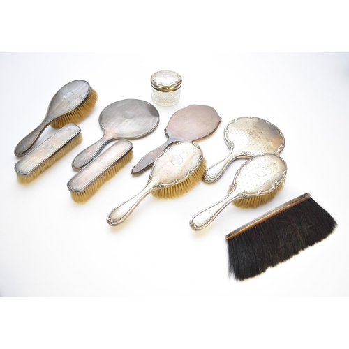 12 - A collection of silver mounted dressing table wares, comprising; three hand mirrors, three hair brus... 