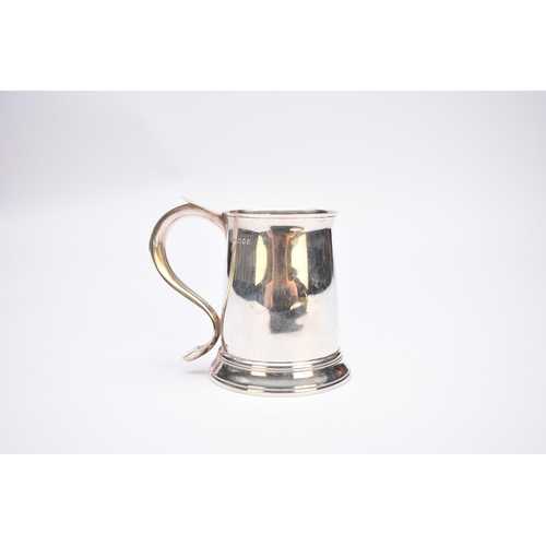 2 - A silver mug, Blackmore & Fletcher Ltd, London 1928, of tapered form with scroll handle, 12cm high, ... 