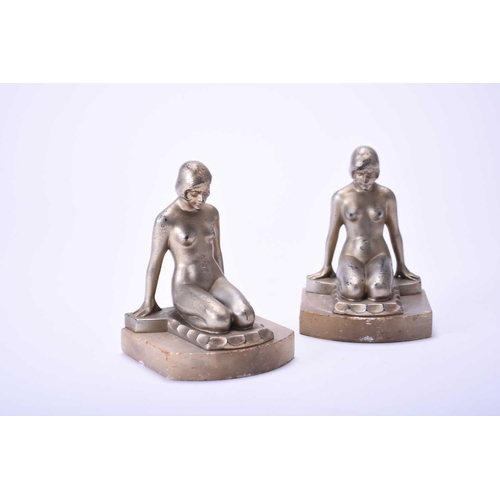 365 - A pair of Art Deco gilt spelter figural bookends, modelled as kneeling nude maidens set on alabaster... 