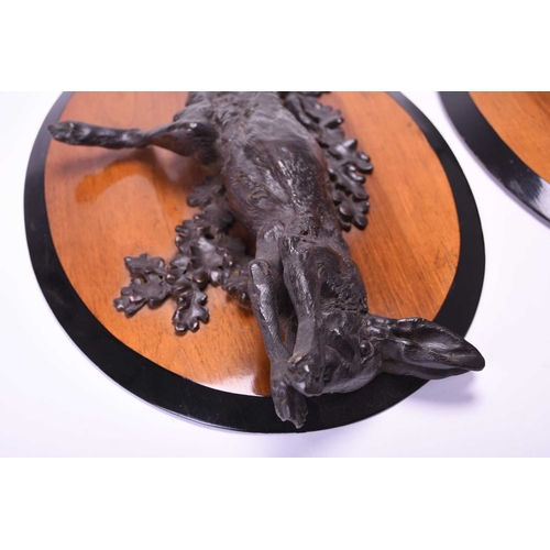 379 - A pair of late 19th century patinated spelter game groups, depicting hares and a squirrel, set on pa... 