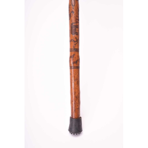 401 - A 19th century incised cane, likely of Colonial Indian origin, the tapering shaft with natural knot ... 