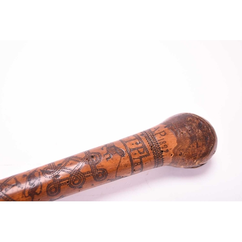 401 - A 19th century incised cane, likely of Colonial Indian origin, the tapering shaft with natural knot ... 