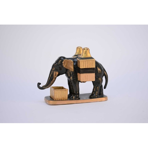 58 - A rare Coalport elephant condiment holder set, circa 1875, modelled as a dark green elephant holding... 