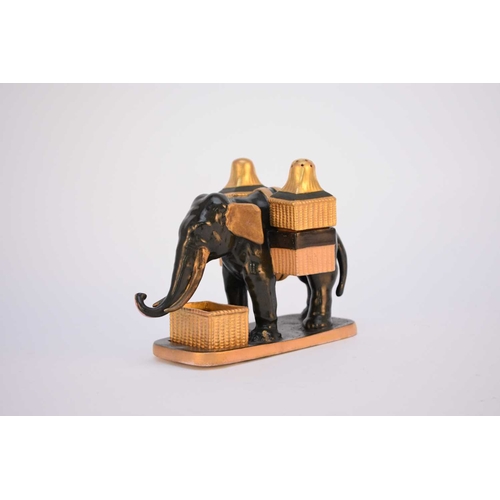 58 - A rare Coalport elephant condiment holder set, circa 1875, modelled as a dark green elephant holding... 