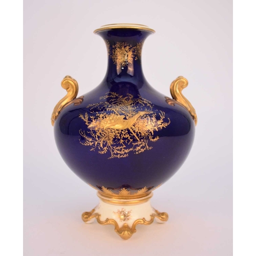 59 - A Coalport vase, circa 1891-1919 of twin-handled form on raised scrolled foot, the dark blue ground ... 