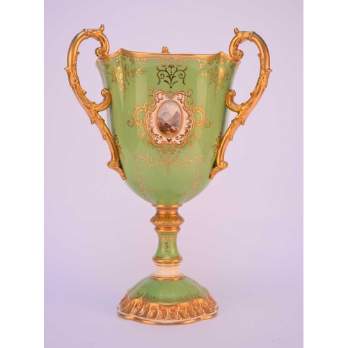 88 - A large Coalport trophy cup, circa 1900-1910, of tri-handled form, the apple green ground with paint... 