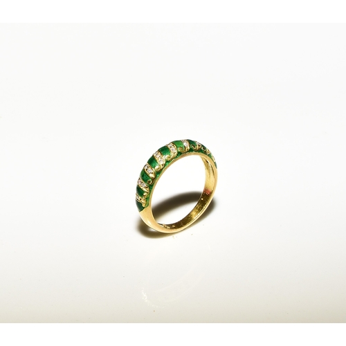 100 - A French diamond and green enamel ring, the tapering band set with graduated diamond set scrolls to ... 