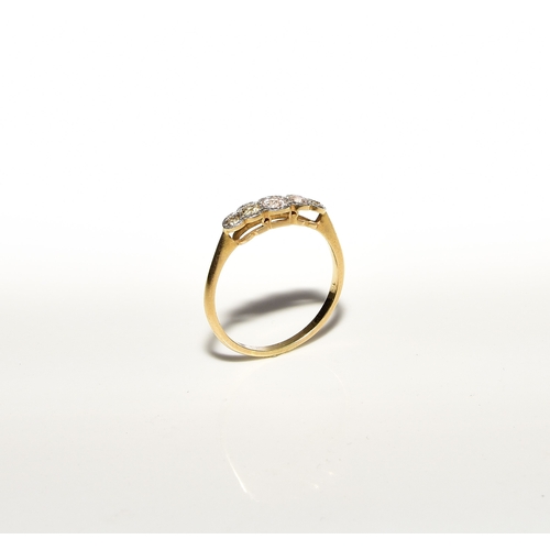 102 - A graduated five stone diamond ring, the old cut diamonds illusion set in white metal to yellow meta... 