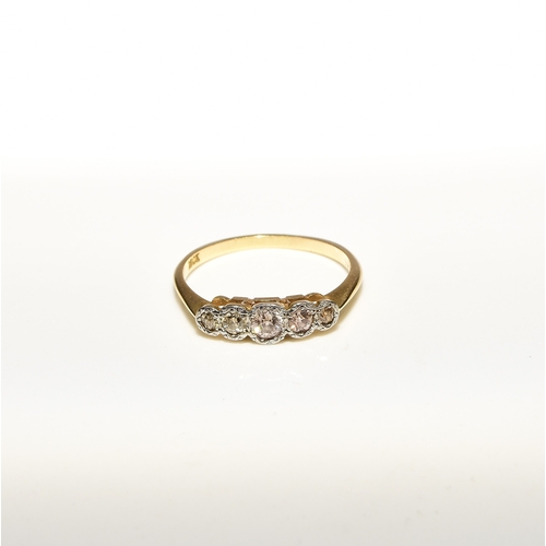 102 - A graduated five stone diamond ring, the old cut diamonds illusion set in white metal to yellow meta... 