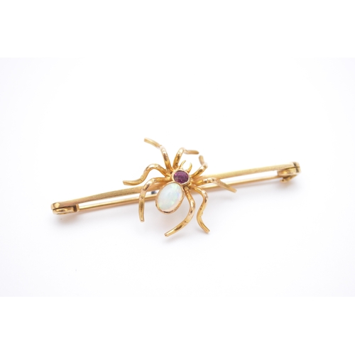 112 - An opal and ruby spider bar brooch, the opal and ruby body mounted in yellow metal, not stamped, 63m... 