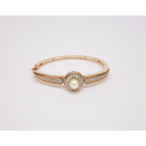 119 - A Victorian style cultured pearl and rose cut diamond hinged bangle, designed as a raised central si... 