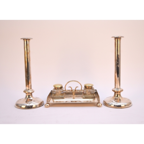 15 - An electroplated desk standish, of rectangular form housing two glass wells, raised on four compress... 