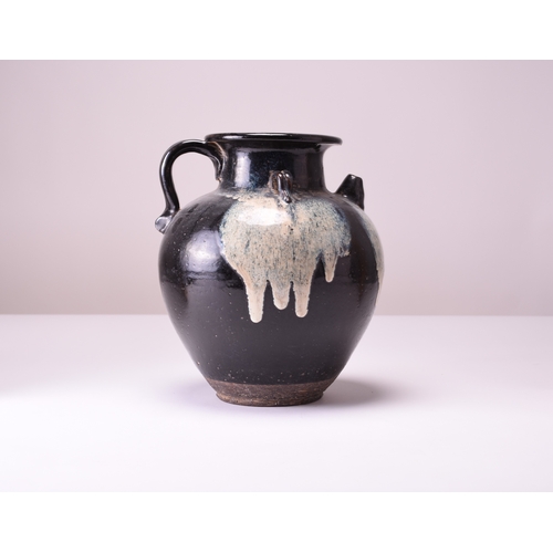 1 - A Chinese Lushan phosphatic splash-glazed ewer, Tang Dynasty The heavily potted vessel with ribbed l... 