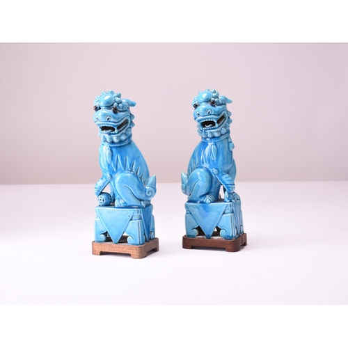 11 - A pair of Chinese turquoise-glazed figures of guardian lions Early 20th century Modelled seated on s... 