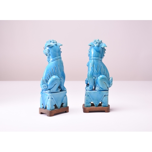 11 - A pair of Chinese turquoise-glazed figures of guardian lions Early 20th century Modelled seated on s... 