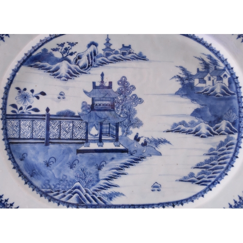 19 - A Chinese blue and white oval platter, 18th century Decorated with pavilions and huts beside a river... 