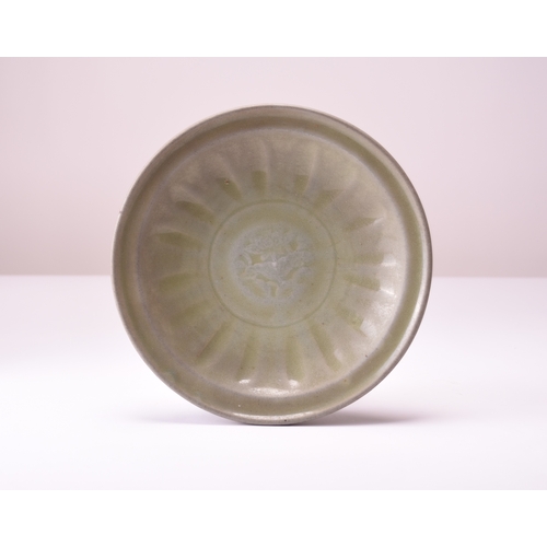 3 - A Chinese Longquan celadon dish, Ming Dynasty Of circular form with everted rim, the centre carved w... 