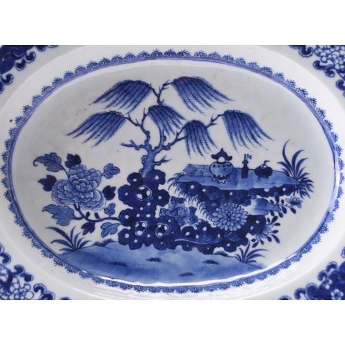 32 - A Chinese blue and white serving dish, 18th century Of lobed oval shape, the deep dish decorated wit... 