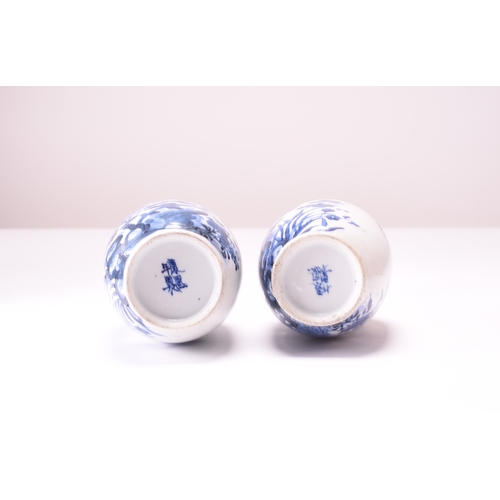39 - A pair of Chinese blue and white bottle vases, Kangxi four-character marks but 19th century Decorate... 