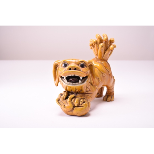 43 - A pair of Chinese yellow sancai-glazed figures of guardian lions Early 20th century The male with hi... 