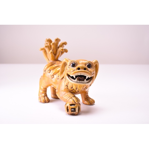 43 - A pair of Chinese yellow sancai-glazed figures of guardian lions Early 20th century The male with hi... 