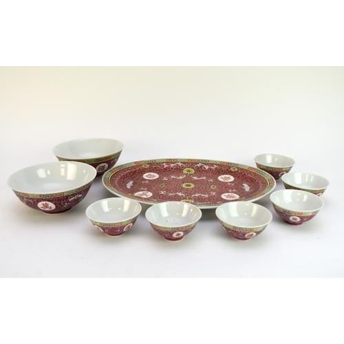 44 - A Chinese famille rose brocade dinner service, 20th century, decorated with scrolling foliage and sh... 