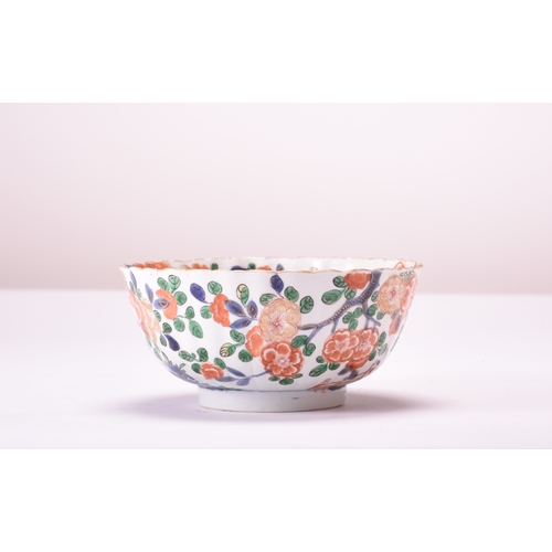 49 - A Chinese Wucai bowl, Kangxi Of fluted and rounded form with deep foot ring, decorated with flowerin... 