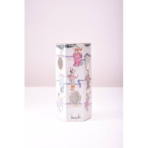 54 - A Chinese famille rose wig stand, 19th century Of hexagonal section and decorated with noble figures... 