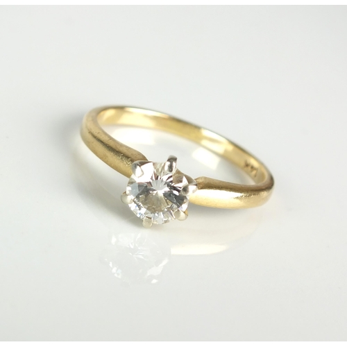 101 - A single stone diamond ring, the brilliant cut diamond claw set in white metal to yellow metal shank... 