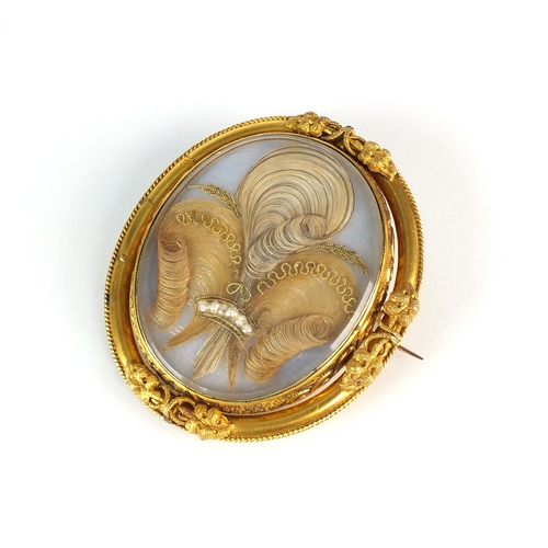 103 - A 19th century swivel locket brooch, the oval central glazed locket housing plume of hair with wirew... 